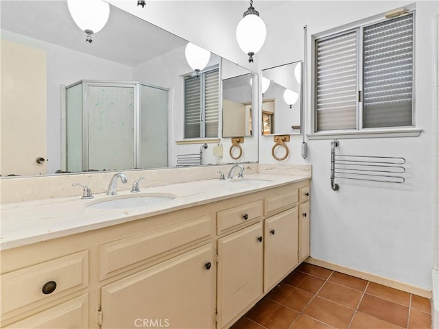 bathroom with walk in shower, vanity, and tile patterned flooring