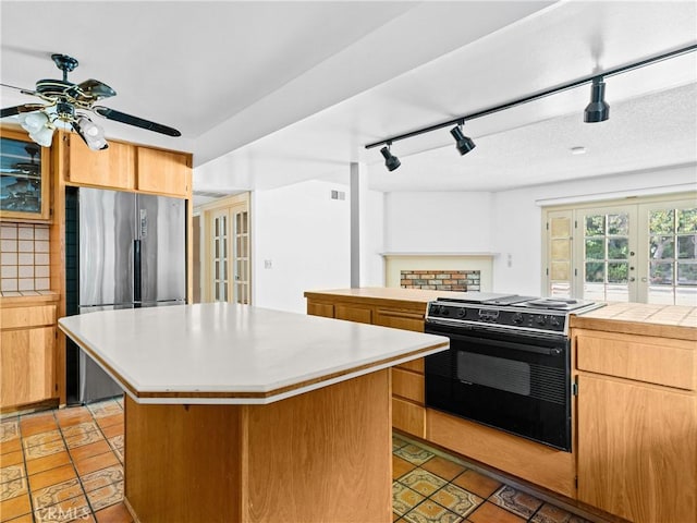 kitchen with french doors, black / electric stove, and a center island