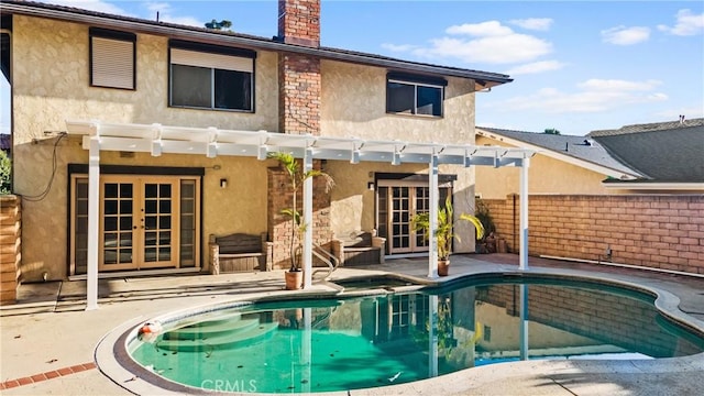 back of house featuring a pergola, a patio area, and french doors