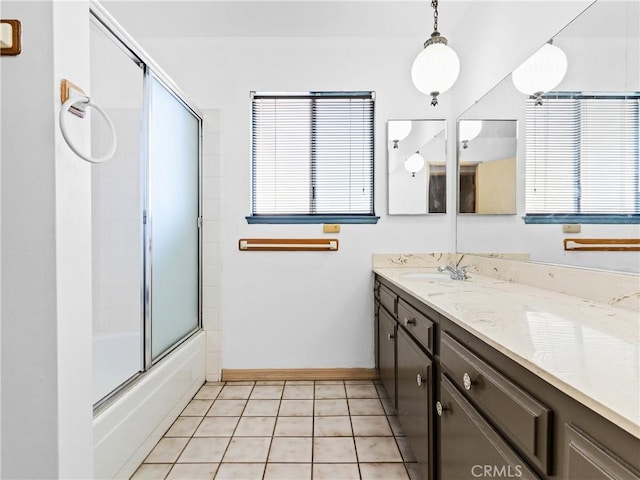 bathroom featuring vanity, tile patterned flooring, and combined bath / shower with glass door