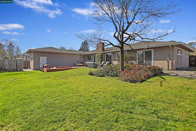 back of house featuring an outdoor living space, a patio area, and a lawn