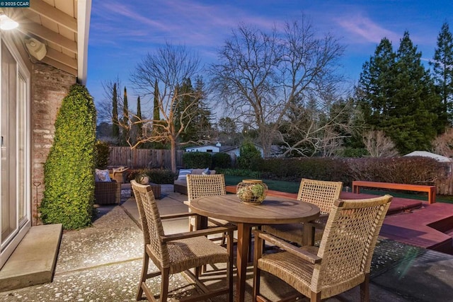 patio terrace at dusk featuring outdoor lounge area