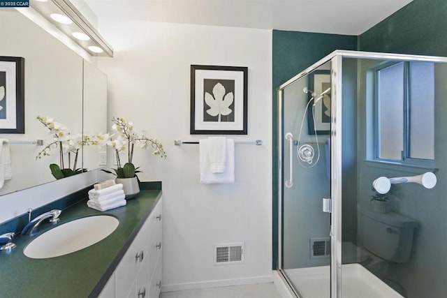 bathroom featuring vanity and an enclosed shower