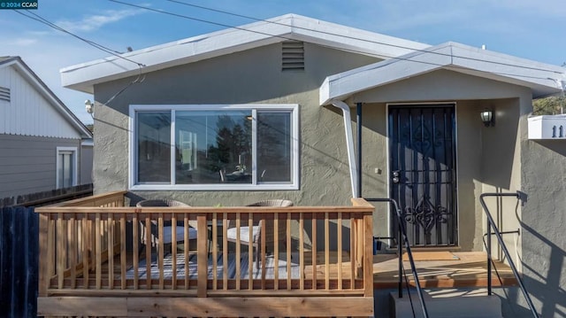 back of property with a wooden deck