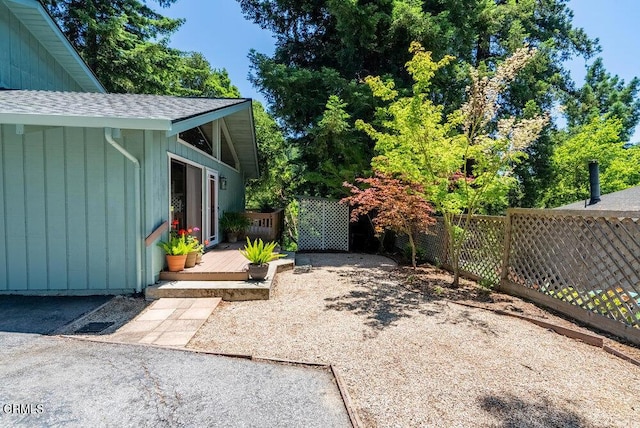 view of yard featuring a wooden deck and a patio area