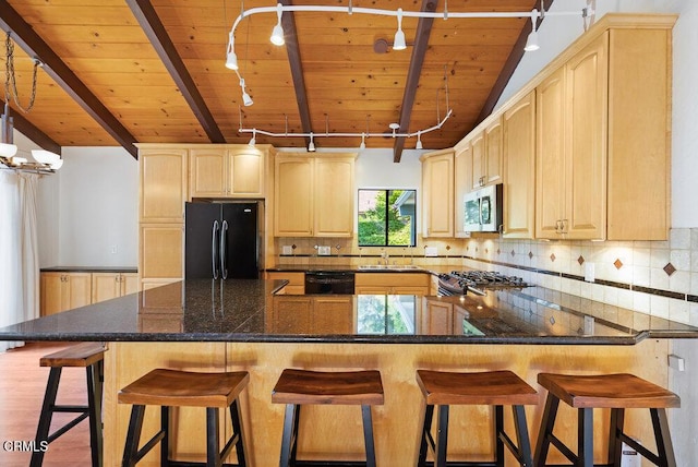 kitchen with light brown cabinets, backsplash, and black appliances