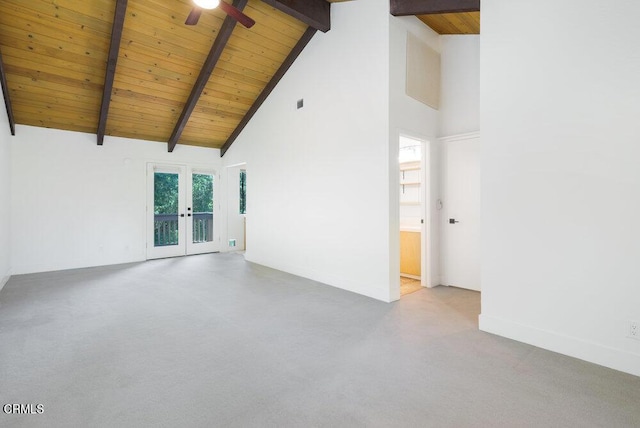 unfurnished room with high vaulted ceiling, beamed ceiling, light colored carpet, wooden ceiling, and french doors