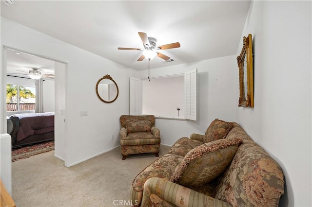 carpeted living area featuring baseboards, visible vents, and a ceiling fan