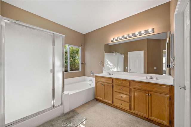 bathroom featuring a garden tub, double vanity, a stall shower, and a sink