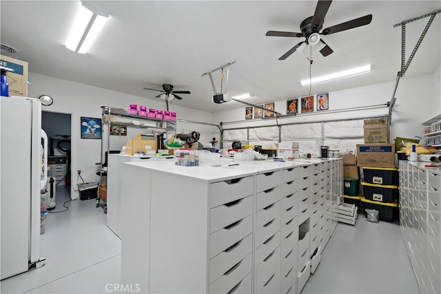 garage featuring ceiling fan, freestanding refrigerator, and a garage door opener