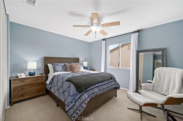 carpeted bedroom featuring ceiling fan, visible vents, and baseboards