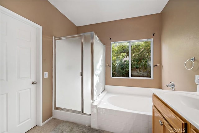 full bathroom featuring vanity, a shower stall, and a bath