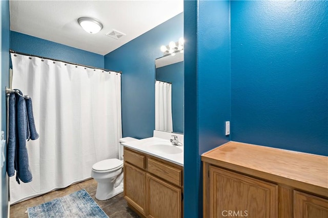 bathroom with visible vents, vanity, tile patterned flooring, and toilet