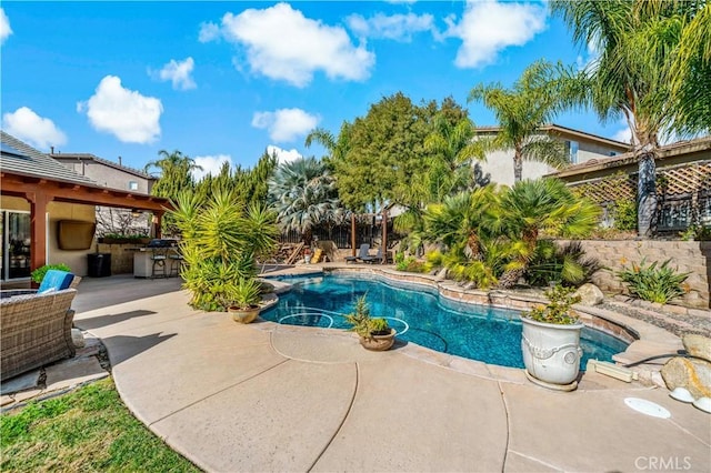 pool featuring a grill, a patio, and outdoor dry bar