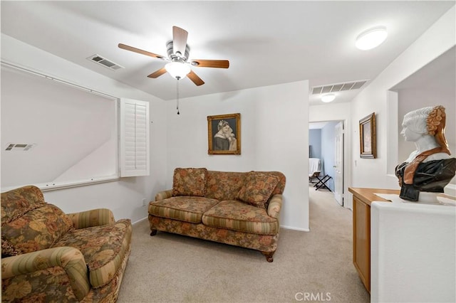 living area with ceiling fan, visible vents, and light colored carpet