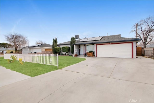 ranch-style house featuring a garage, a front lawn, and solar panels