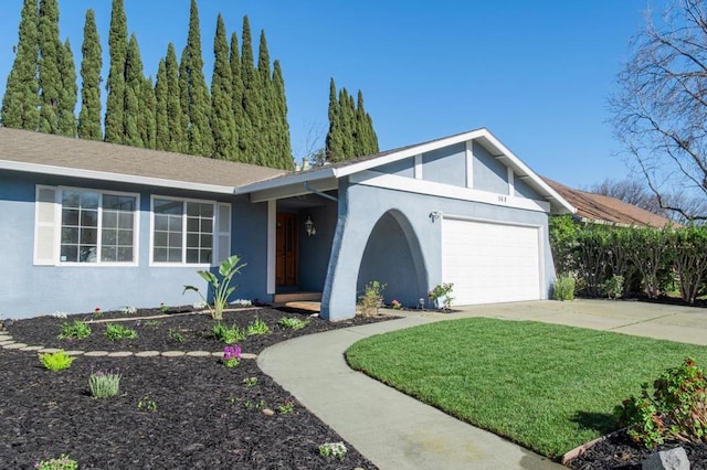 ranch-style home with a garage and a front lawn