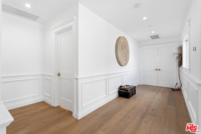 corridor with light hardwood / wood-style flooring