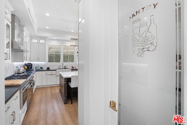 bathroom with vanity, hardwood / wood-style flooring, and decorative backsplash