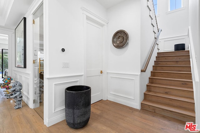 staircase with hardwood / wood-style floors