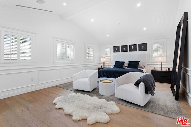 bedroom featuring light hardwood / wood-style flooring and lofted ceiling with beams