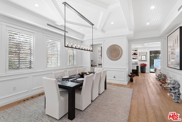 dining room with coffered ceiling, beam ceiling, light hardwood / wood-style floors, and a wealth of natural light