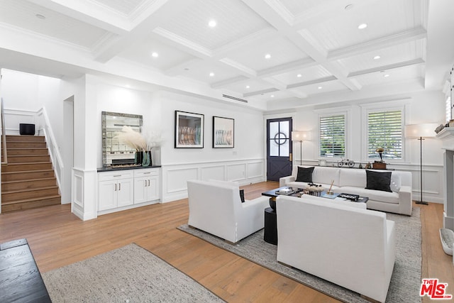 living room featuring coffered ceiling, ornamental molding, beam ceiling, and light hardwood / wood-style flooring