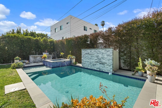 view of pool featuring an in ground hot tub