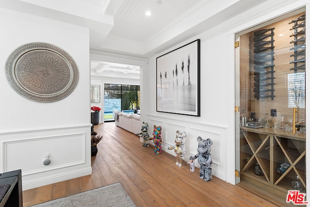 hall with crown molding and hardwood / wood-style floors