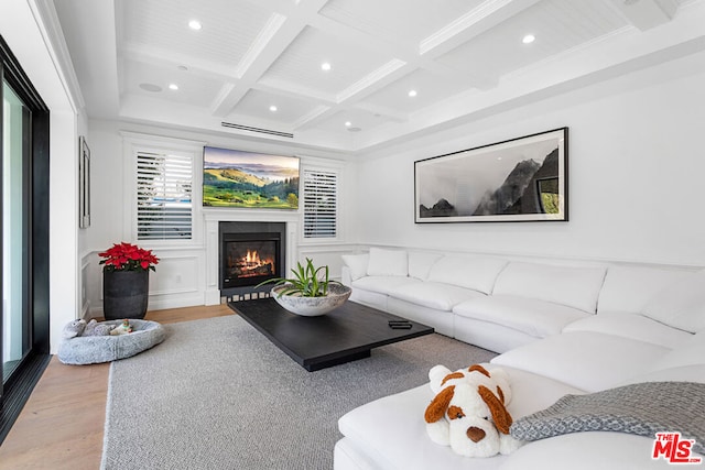 living room with beamed ceiling, crown molding, coffered ceiling, and light wood-type flooring