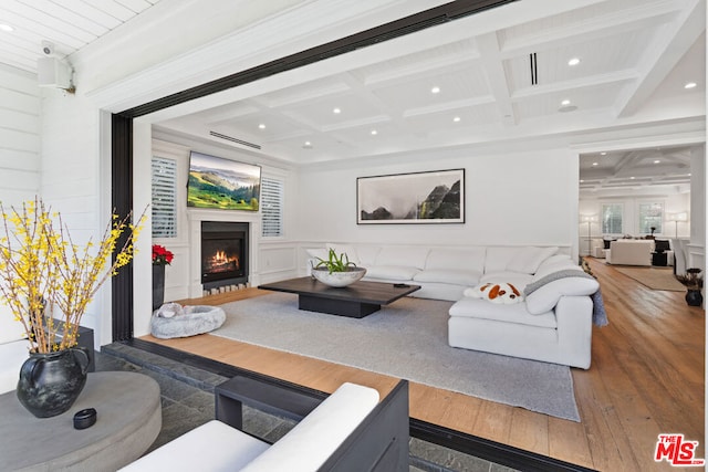 living room with wood-type flooring, coffered ceiling, and beam ceiling