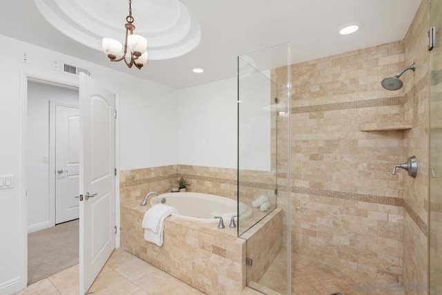 bathroom featuring tile patterned flooring, independent shower and bath, and an inviting chandelier