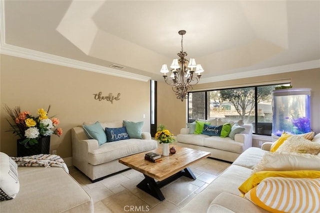 living room with a tray ceiling, ornamental molding, and a chandelier