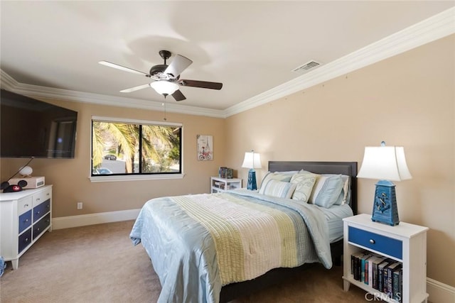 carpeted bedroom with ceiling fan and ornamental molding