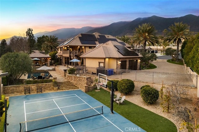 view of sport court with a gazebo, a mountain view, and tennis court