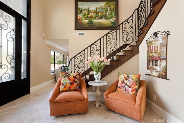 foyer featuring a towering ceiling