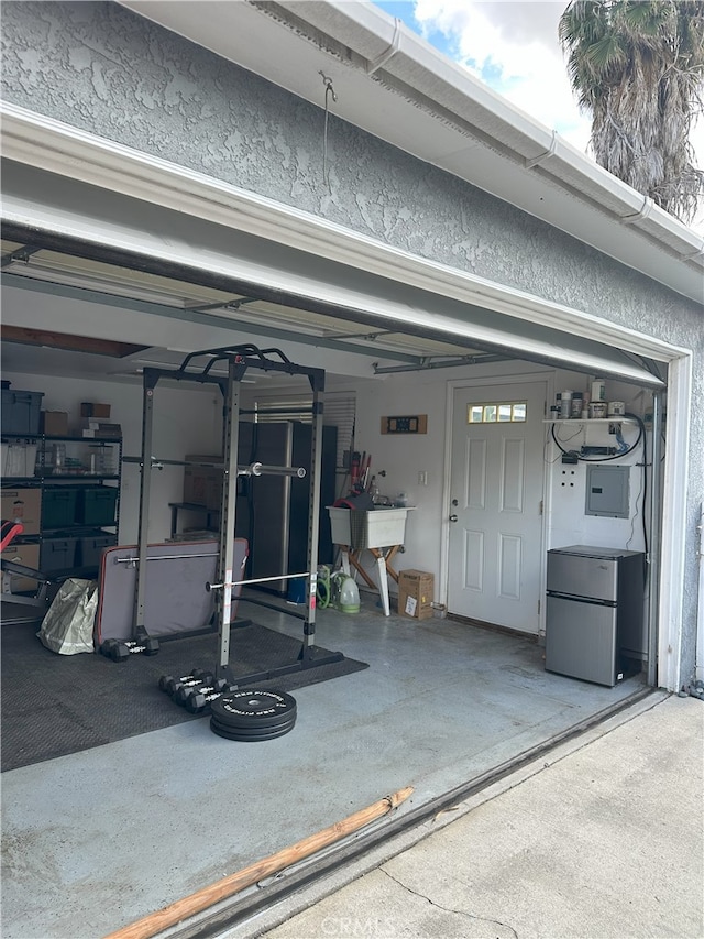 garage with stainless steel refrigerator