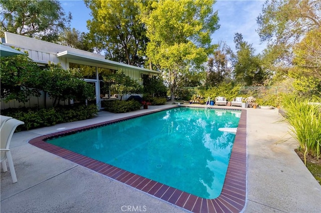 view of swimming pool featuring a patio area