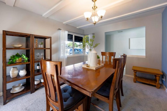 carpeted dining area with a chandelier and beamed ceiling