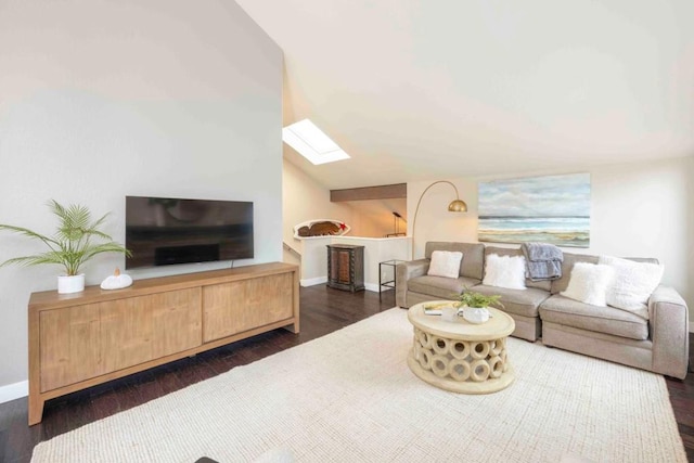 living room featuring dark hardwood / wood-style floors and vaulted ceiling with skylight