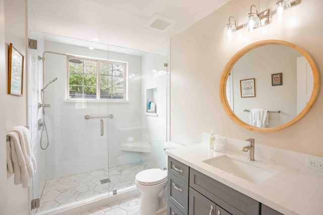 bathroom featuring vanity, toilet, and walk in shower