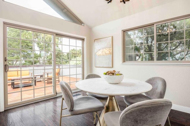 dining room with wood-type flooring and lofted ceiling