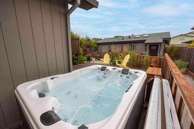 wooden terrace featuring a hot tub