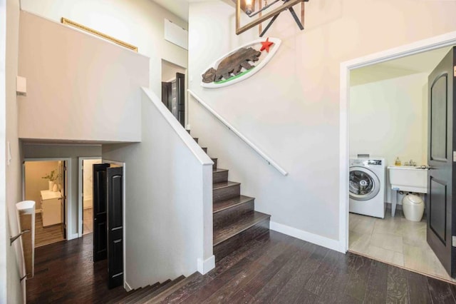 staircase featuring wood-type flooring and washer / clothes dryer