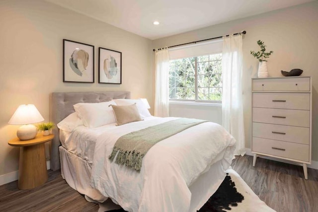 bedroom with dark hardwood / wood-style floors