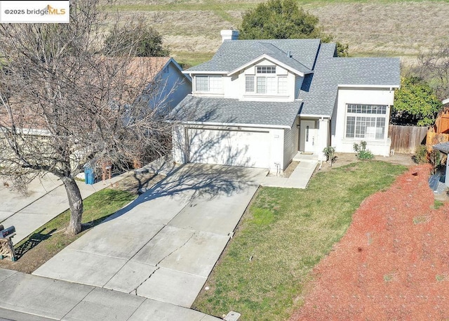 view of front property with a garage and a front yard