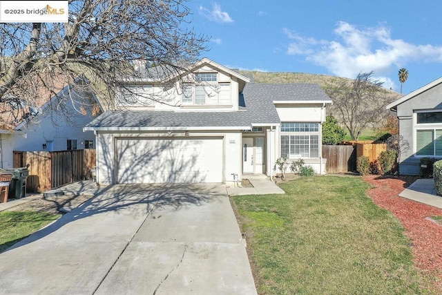 view of front of property with a garage and a front lawn