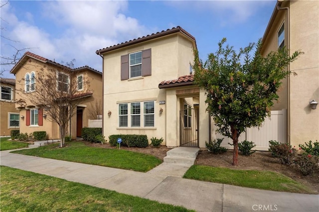 mediterranean / spanish house with a front lawn