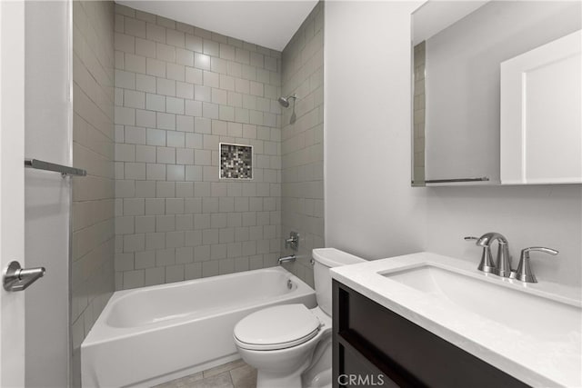 full bathroom featuring vanity, tiled shower / bath, and toilet