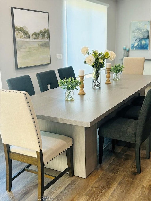 dining space with hardwood / wood-style floors